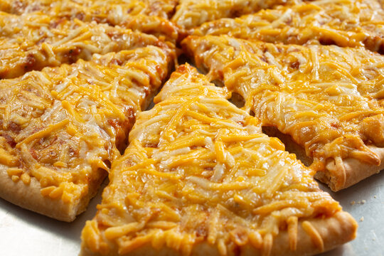 A closeup view of a sliced dairy-free, gluten-free plain cheese pizza.