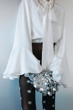 Chic fashion detail woman portrait with silver clutch
