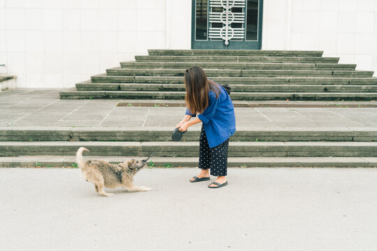 Woman with her mixed breed dog in the city