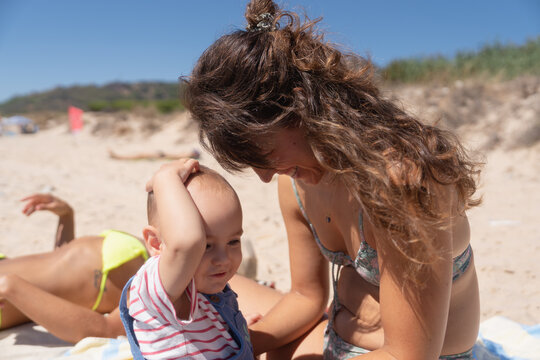 Parent comforting child on beach