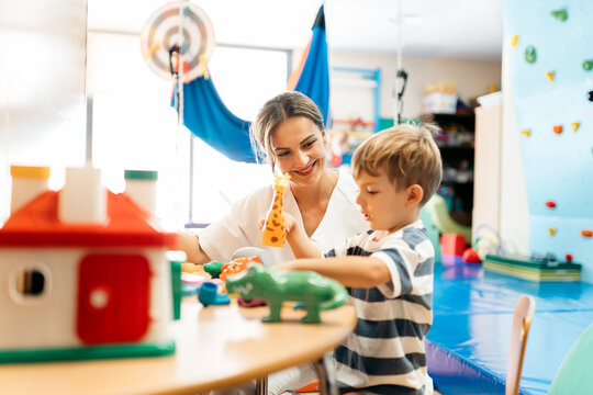 Child developing fine motor skills with occupational therapist