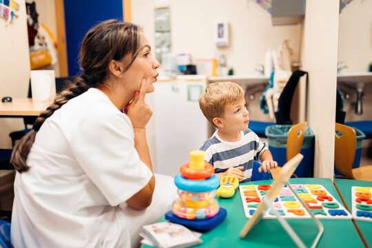 Speech therapist helping child with language development