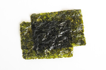 Two pieces of Gim, also known as roasted dried seaweed. A versatile ingredient used for wrapping rice or enjoyed on its own as a healthy, low-calorie snack.