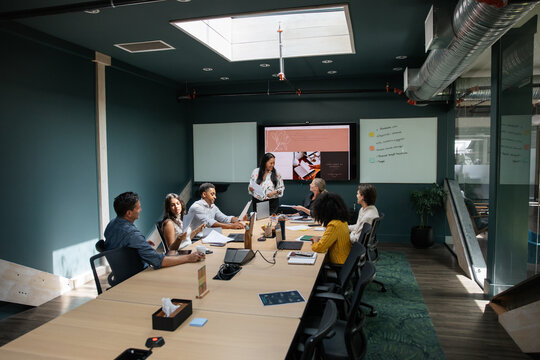 Colleagues discussing work strategies during a team meeting