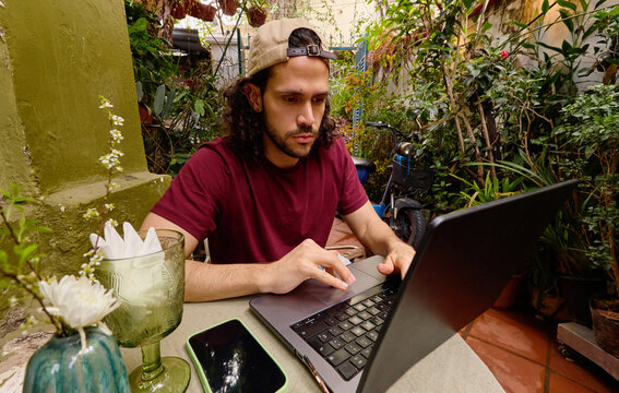 Man working on laptop at outdoor caf&eacute; in Vietnam