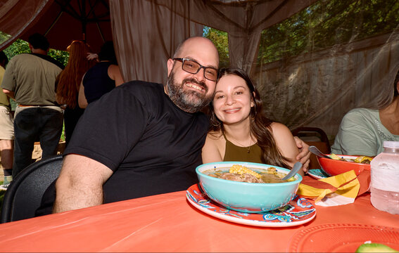 Man and woman seated at table with bowl of food