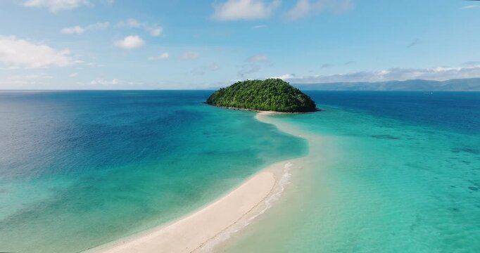 Aerial view of islet and sandbar with turquoise sea water and waves. Romblon Island. Romblon, Philippines.