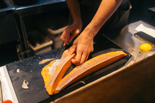 Chef slicing salmon with precision