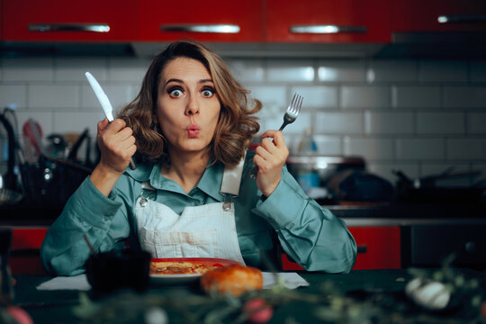 Woman Holding Knife and Fork and Can Not Wait to Eat Omelet. Greedy lady can not wait to have her breakfast first thing in the morning
