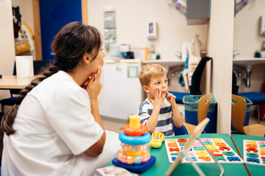 Speech therapist helping child with language development