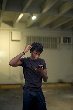 Young Man Checking His Phone in Urban Space