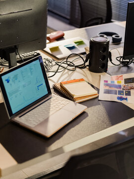 Office Desk With Laptop and Design Materials