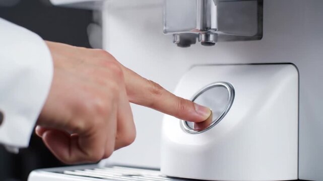 Hand Pressing Button on Medical Device.