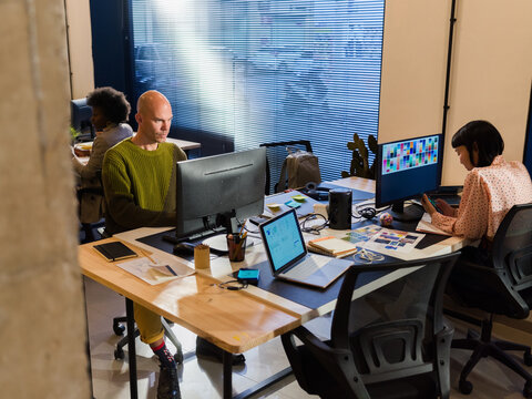 Creative Workspace With Individuals Engaged in Work