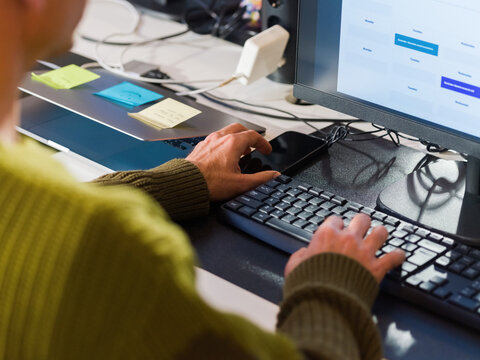 Man checking smartphone at work 