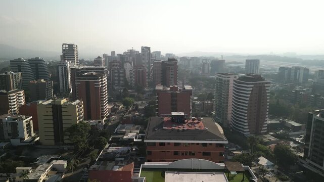 Aerial downtown Guatemala City skyscrapers in zona 14 with white smoggy sky