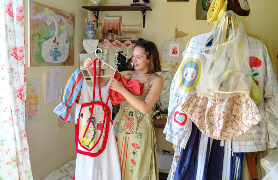 a female designer shows off her clothes