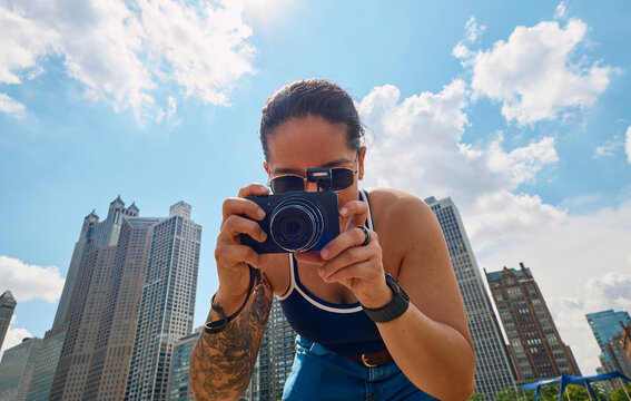 Woman taking photo with camera outdoors
