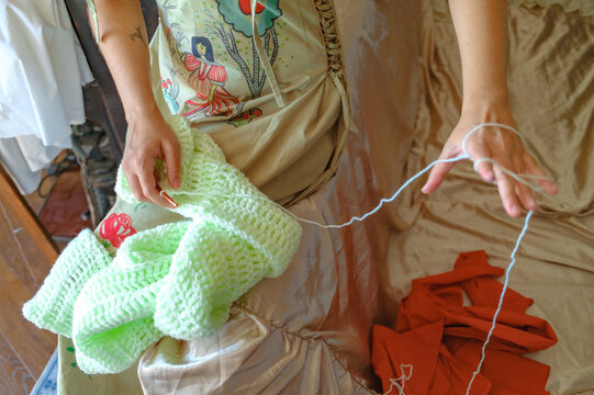 a woman's hands with knitting threads