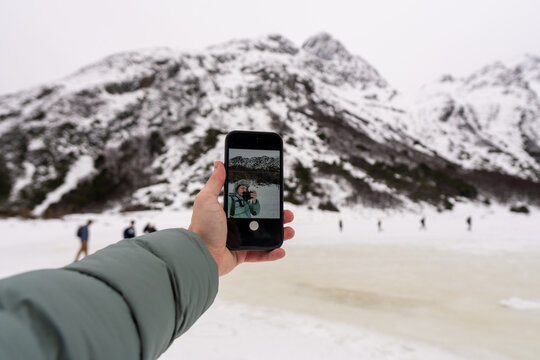 Snowy Landscape With Hikers Taking Selfies in the Mountains