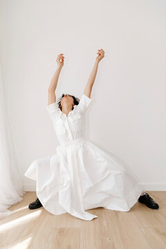 Woman dancer performing contemporary moves in white dress