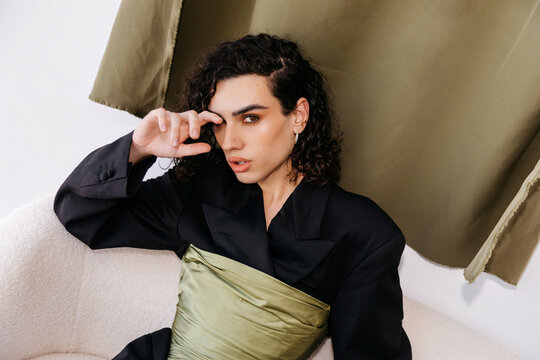 Queer man posing in stylish fashion outfit