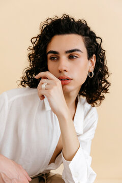 Queer man looking away thoughtfully