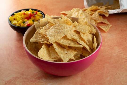 A view of a bowl of white corn tortilla chips.