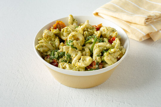 A view of a bowl of trottole pesto pasta salad.