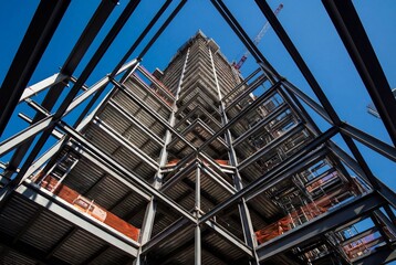 Fototapeta premium Low angle view of a steel skyscraper frame under construction