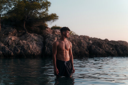 Thoughtful young man standing in water