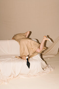 Beige Dress Falls On Sofa Studio Shot