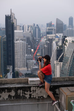 Rooftop Photographer Over Bangkok Skyline