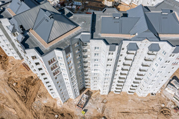 gray corrugated metal roof of newly built multistory apartment house. aerial photo.