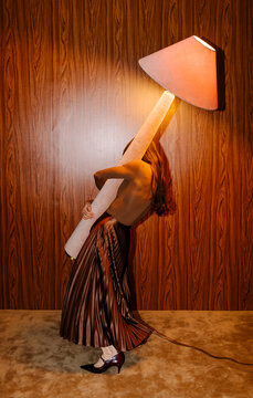Person Carries Giant Lamp In Retro Room
