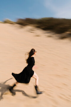 Runner In Desert Sand Dunes Under Blue Sky