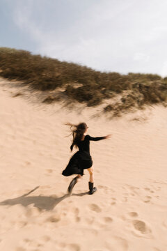 Runner On Sand Dunes In Windy Day