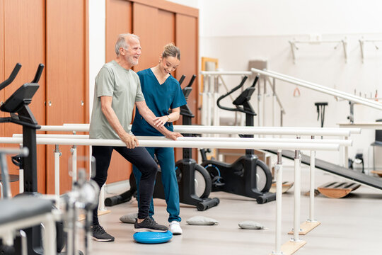 Senior man receiving physical therapy rehabilitation support