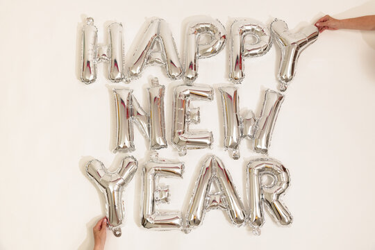 Silver balloons reading happy new year