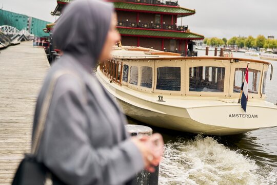 Woman by the Water in Amsterdam Waiting for a Boat