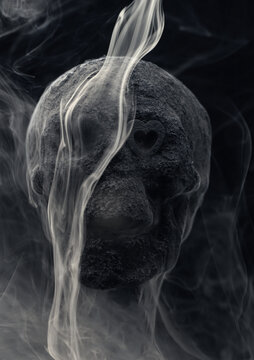 Skull covered in charcoal dust homemade with smoke and dry ice swirling around creating scarry spooky patterns
