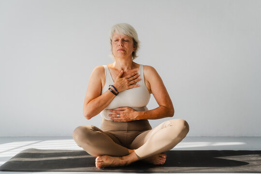 Senior woman focusing on yoga