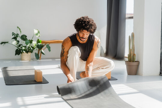Man prepares his yoga setup