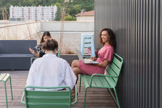 Women Working and Relaxing at a Rooftop Terrace in the City