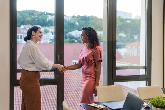 Meeting Between Two Women in an Office With a City View