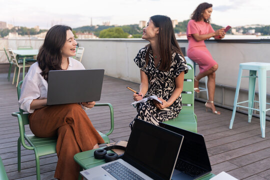 Women Working and Enjoying Discussion on a Rooftop Terrace