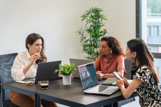 Team Brainstorming in a Modern Office Setting During the Day