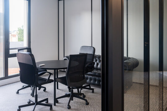 Modern Conference Room With Black Chairs and Round Table