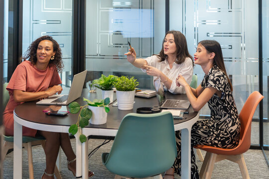 Women Collaborating in a Modern Office Space During a Meeting
