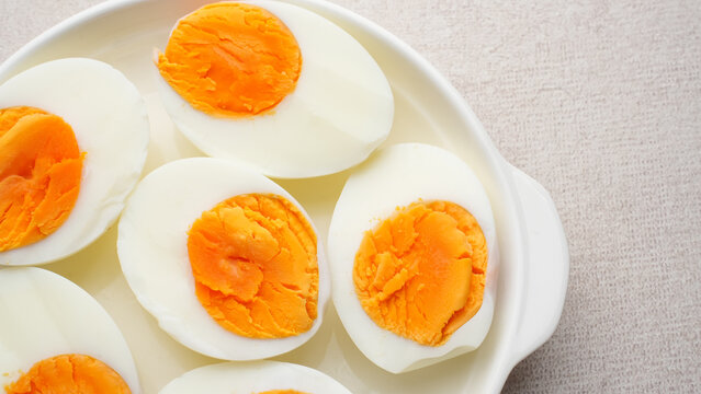 Hard boiled eggs peeled and cut in plate